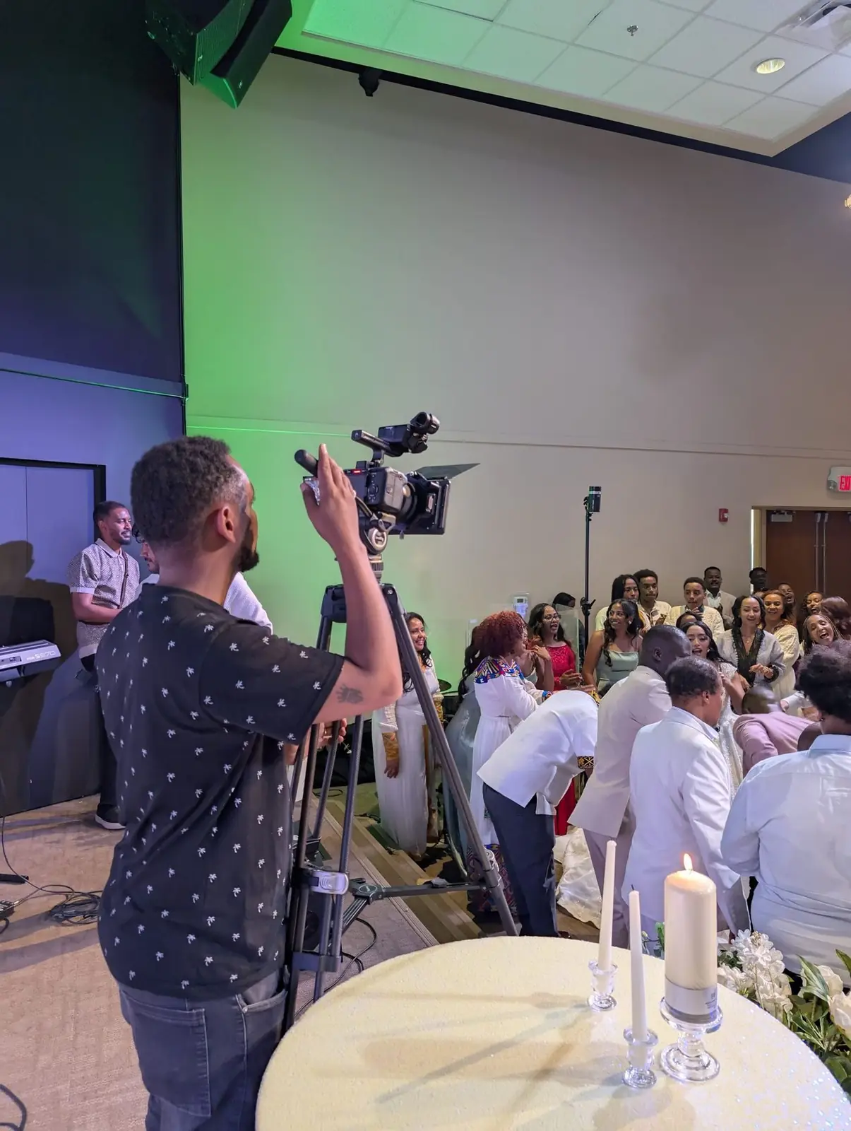 Daniel filming a wedding reception on an ICAN cinema camera